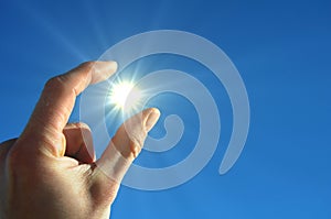 Hand sun and blue sky
