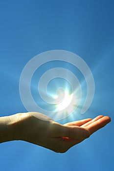 Hand sun and blue sky