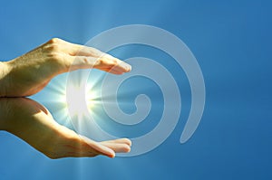 Hand sun and blue sky