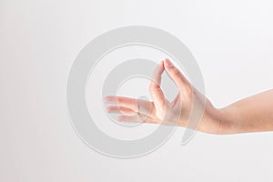 Hand supine and touching tip of thumb and forefinger together on white background; posturing like holding very small, thin and