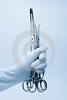 Hand of surgeon with forceps