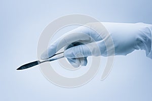 Hand of surgeon with scalpel photo