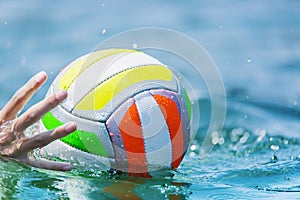Hand of swimmer water beachball