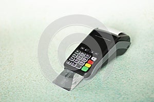 Hand swiping credit card in wireless modern bank. Payment with NFC tecnology and POS terminal on light background