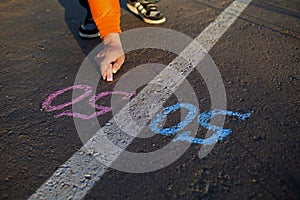 The hand with the symbol of gender equality on the pavement, the concept of gender