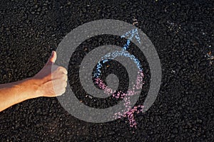 The hand with the symbol of gender equality on the pavement, the concept of gender