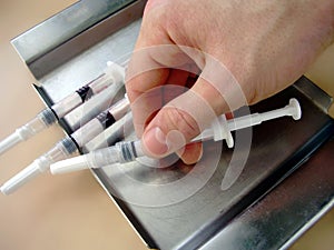 Hand with syringes...