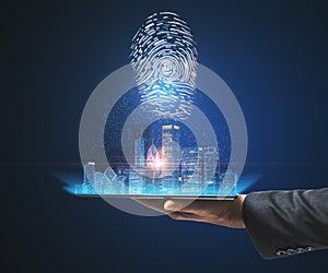 Hand with a tablet holding a city view hologram on a blue background. Internatonal business and market concept photo