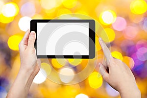 Hand with tablet pc on yellow and blue background