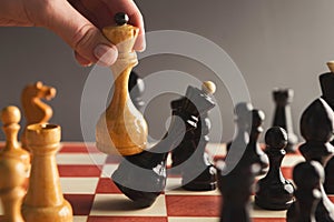 Hand take checkmate on chessboard during game