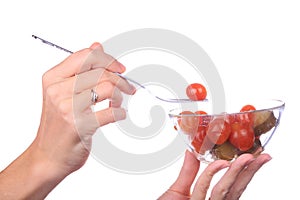 Hand take fork with tomato