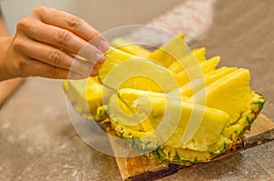 Hand take a Pineapple slice