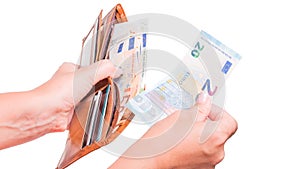 The hand takes out 20 euro money from the wallet. Hand sharing euro banknotes.