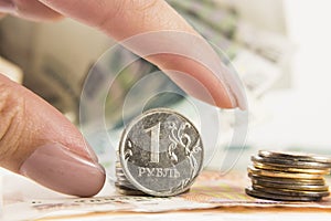 Hand takes the ruble and dollars with banks of rubles