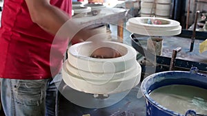 Hand taking cotton from plant ready to harvest.Hands of a potter, creating a bowl using a die, ceramic polishing process