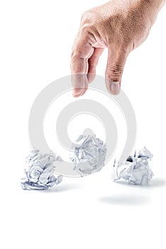 Hand taking a crumpled paper ball isolated