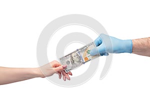 Hand taking money from hand in medical gloves passing over white background