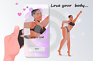 Hand taking photo of girl in bikini on smartphone camera social network love your body concept