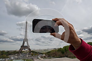 Hand taking selfie at Paris tour eiffel