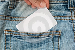 Hand taking white label, card with information copy space in a jeans pocket, sale and discount concept