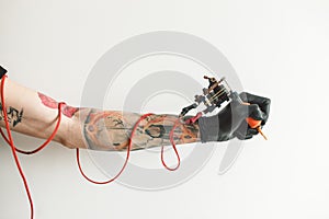 Hand tattoo artist with the tattoo machine