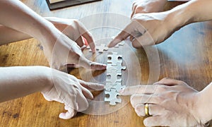 Hand team put missing jigsaw puzzle on the air