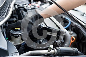 Hand Technician checking brake fluid in engine room maintenance and basic service concept of the car and brake system