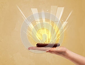 Hand with telephone and yellow light