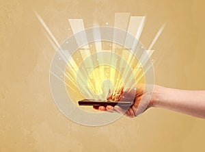 Hand with telephone and yellow light