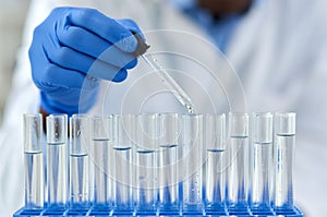 Hand, test tubes and pharmaceutical development for drugs, medicine and medical research. Person, laboratory and