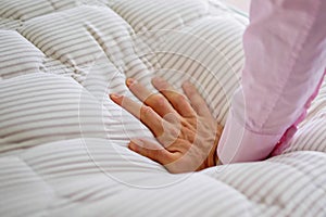 Hand testing memory foam mattress topper