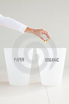 hand throwing an apple core to a corresponding rubbish bin. Orga