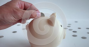 Hand throwing coin into piggy bank. Movement hand with coin towards piggy bank allows immerse yourself in process
