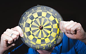 Hand throwing dart to dartboard