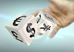 Hand throwing 2 dice with currency symbols. Concept for financial advice, trading, markets. photo