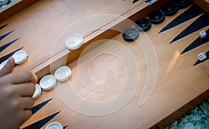 Hand throwing dice playing Backgammon game.