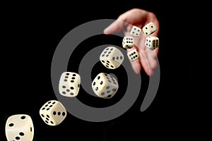 Hand throwing dice towards viewer