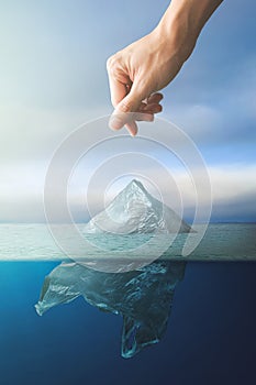 Hand throwing plastic bag floating in ocean, environment pollution