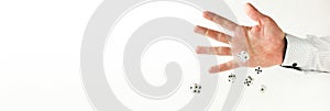 Hand throws dice on white background