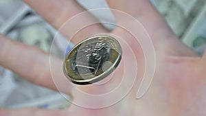 The hand throws euro coin