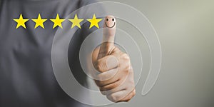 Hand with thumb up positive emotion smiley face icon and 5 star with copy space. Emotional smiley faces showing excellent