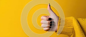 The Hand with a Thumbs-Up Gesture Against a Bright Yellow Background AI generated image