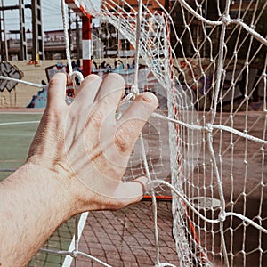 Hand tied with a rope net in the soccer field