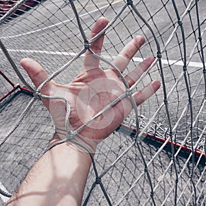 Hand tied with a rope net in the soccer field