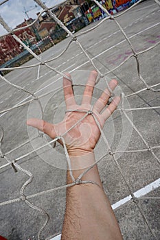 Hand tied with a rope net in the soccer field