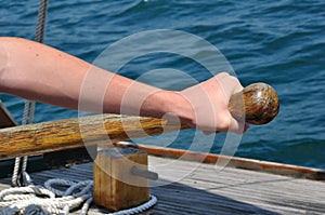 Hand on Tiller Steering a Schooner Sailboat