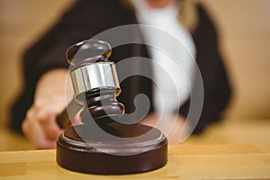 Hand about to bang gavel on sounding block photo