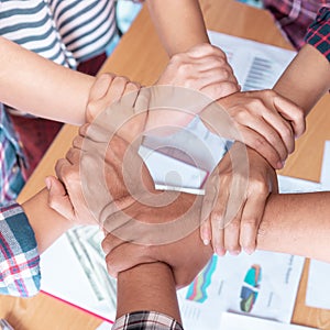 Hand together in business meeting for team concept