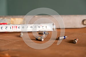 Hand tools for building and construction mixed with screwdriver bits, vintage spirit level or bubble level and tape measure on a