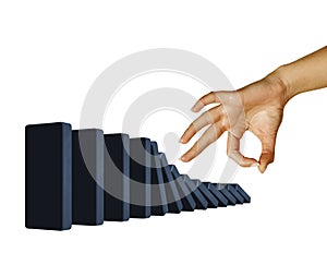Hand toppling dominoes photo